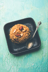 Traditional Jaggery Rice or Gur wale chawal in Hindi, served in a bowl with spoon. selective focus