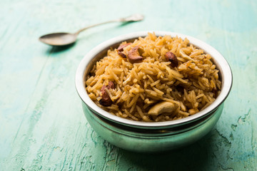 Traditional Jaggery Rice or Gur wale chawal in Hindi, served in a bowl with spoon. selective focus