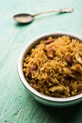 Traditional Jaggery Rice or Gur wale chawal in Hindi, served in a bowl with spoon. selective focus