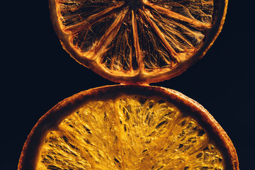 Still life with dried slices of orange, lemon on the  black background. Selective and soft focus.
