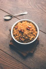 Traditional Jaggery Rice or Gur wale chawal in Hindi, served in a bowl with spoon. selective focus