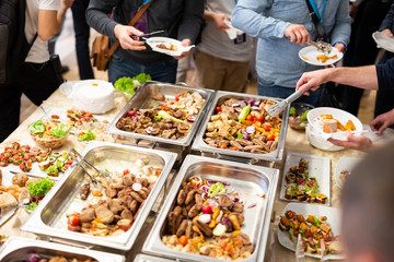 Scooping the food. Buffet food at restaurant. Catering food.