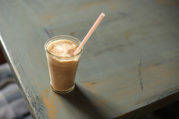 glass with a latte on a dark background.