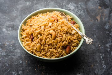 Traditional Jaggery Rice or Gur wale chawal in Hindi, served in a bowl with spoon. selective focus