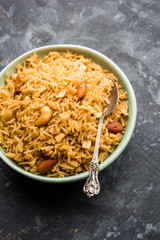Traditional Jaggery Rice or Gur wale chawal in Hindi, served in a bowl with spoon. selective focus