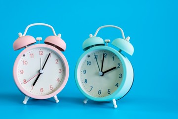 Alarm clock on blue background