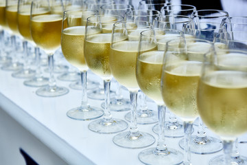 Glasses with white wine on blurred background