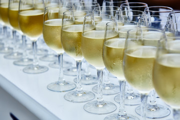 Glasses with white wine on blurred background