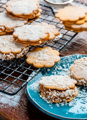 Freshly baked sandwich cookies filled with caramelized milk and coconut