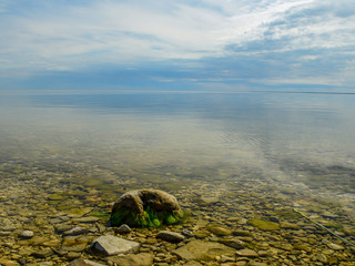 Beautiful Bay and rocky beach Hijuma. Plants and stones in the foreground, Estonia