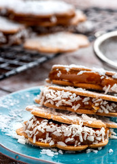 Freshly baked sandwich cookies filled with caramelized milk and coconut