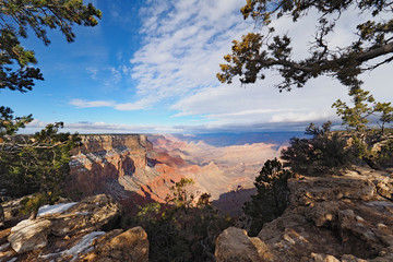 View of the Grand Canyon under a complex cloudscape from the South Rim Trail in Grand Canyon National Park, Arizona, in winter.