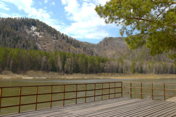 river with a hilly shore in the spring when daylight