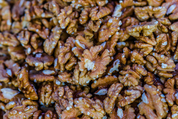 Fresh walnut seeds in a pile on display for sale. Healthy organic natural food. Brown color background or pattern