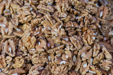 Fresh walnut seeds in a pile on display for sale. Healthy organic natural food. Brown color background or pattern