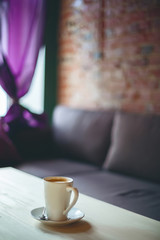 Coffee cup on the table in empty cafe