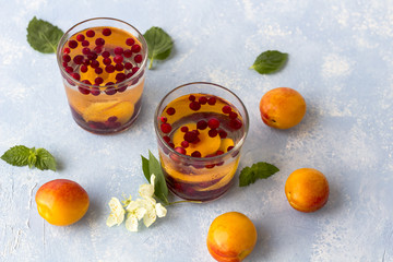 Fresh cool detox drink with berries and peaches or aprikotes.