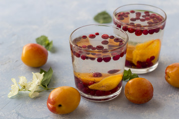 Fresh cool detox drink with berries and peaches or aprikotes.