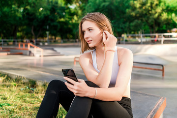 Fototapeta na wymiar teenage girl using headphones in the park after school