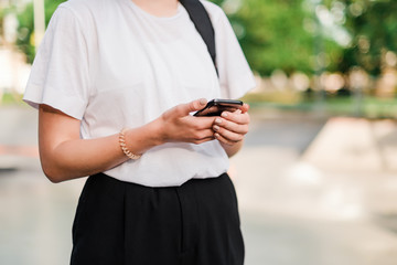 student using phone in the park