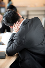 Asian businessman feels work with stress.