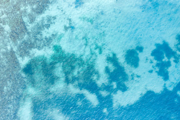 Aerial view of rocky beach at the sea and the turquoise ocean shore