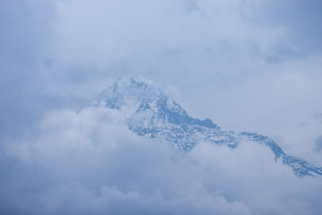 The holy mountain of Machapuchare with clouds