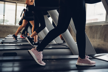 Fototapeta na wymiar Close up shoe and legs. Asian women running in a gym on a treadmill.