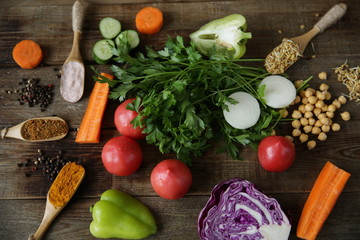 Top view Flat lay Organic Healthy food, including sprouted legumes, Fenugreek and chickpeas and turmeric spices nutmeg Himalayan salt Bulgarian pepper vegetables tomatoes carrots red cabbage parsley.