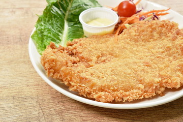 batter fried dolly fish wrapped bread steak with salad on dish
