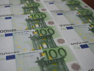 Many new 100 Euro banknotes are neatly arranged in rows