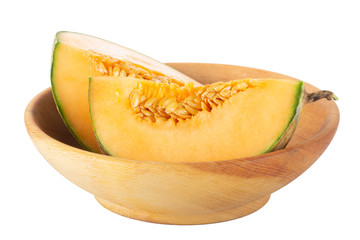 heap of slices of cantaloupe in wooden plate isolated on white background