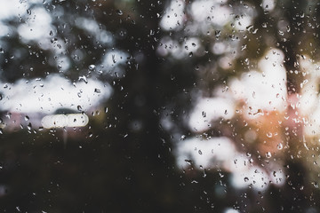 Drops Of Rain On Glass Background. Street Bokeh Lights Out Of Focus. Abstract Backdrop