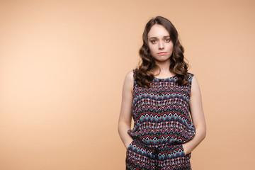 Upset young beautiful woman standing with crossed hands isolated at white studio background medium...
