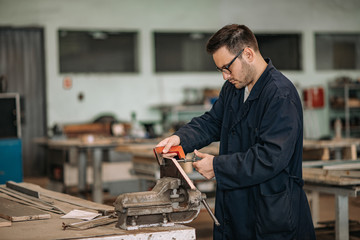 Manual worker working with bench hold fast at metal industry.