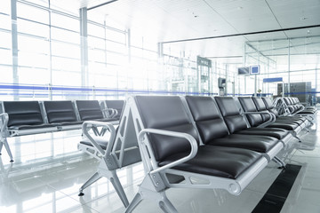 Empty passenger waiting seat in airport departure gate, Front view seating with glass background