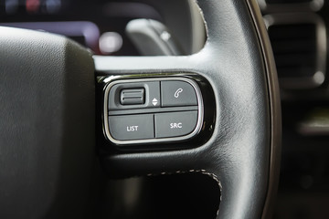 selective focus of steering wheel near gear shift handle in luxury car