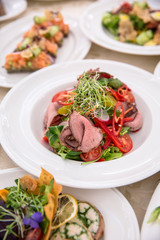 Food Table Celebration Delicious Party Meal Concept. A lot of food. Served for wedding, anniversary, other holiday. Banquet dishes in the restaurant