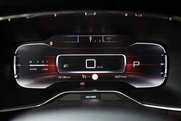 Car dashboard panel with speedometer, tachometer, odometer, fuel gauge and gear position indicator.