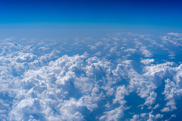 White clouds and blue sky, a view from airplane window