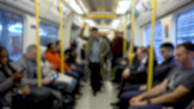 Anonymous Commuters Looking At Phones inside Subway Train