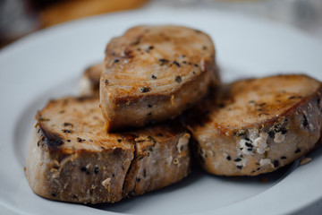 fried tuna fillet on white plate