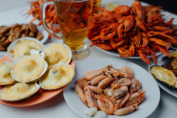 boiled shrimps, scallops with cheese, boiled crayfish and beer