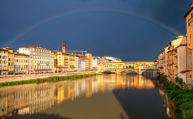 Rainbow over the medieval stone bridge Ponte Vecchio over Arno river in Florence, Tuscany, Italy. Florence cityscape. Florence architecture and landmark.
