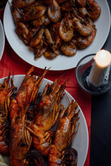 a candlelit dinner with shrimps and rock lobster