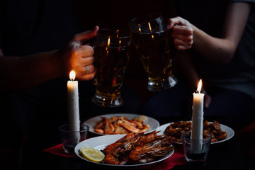 clink glasses of beer, shrimps and lobsters
