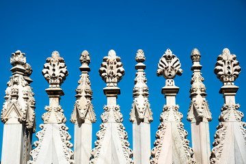 Spires and statues on the roof of Duomo Milan Cathedral, Italy. 