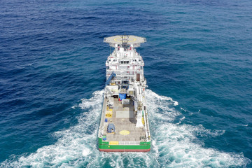 Green Offshore supply ship with Helipad at sea, Aerial image.