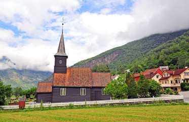 Fototapeta premium Old wooden Flam stave church and mountains