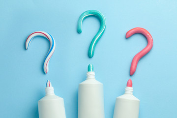 Question mark from toothpaste. Concept of choosing good toothpaste for teeth whitening. Tube of...